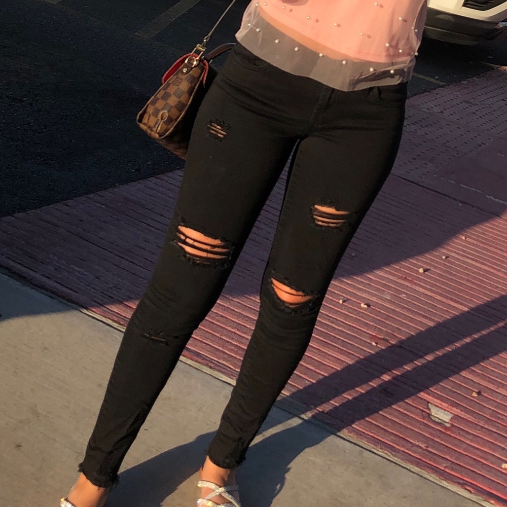 black jeans with torn detailing